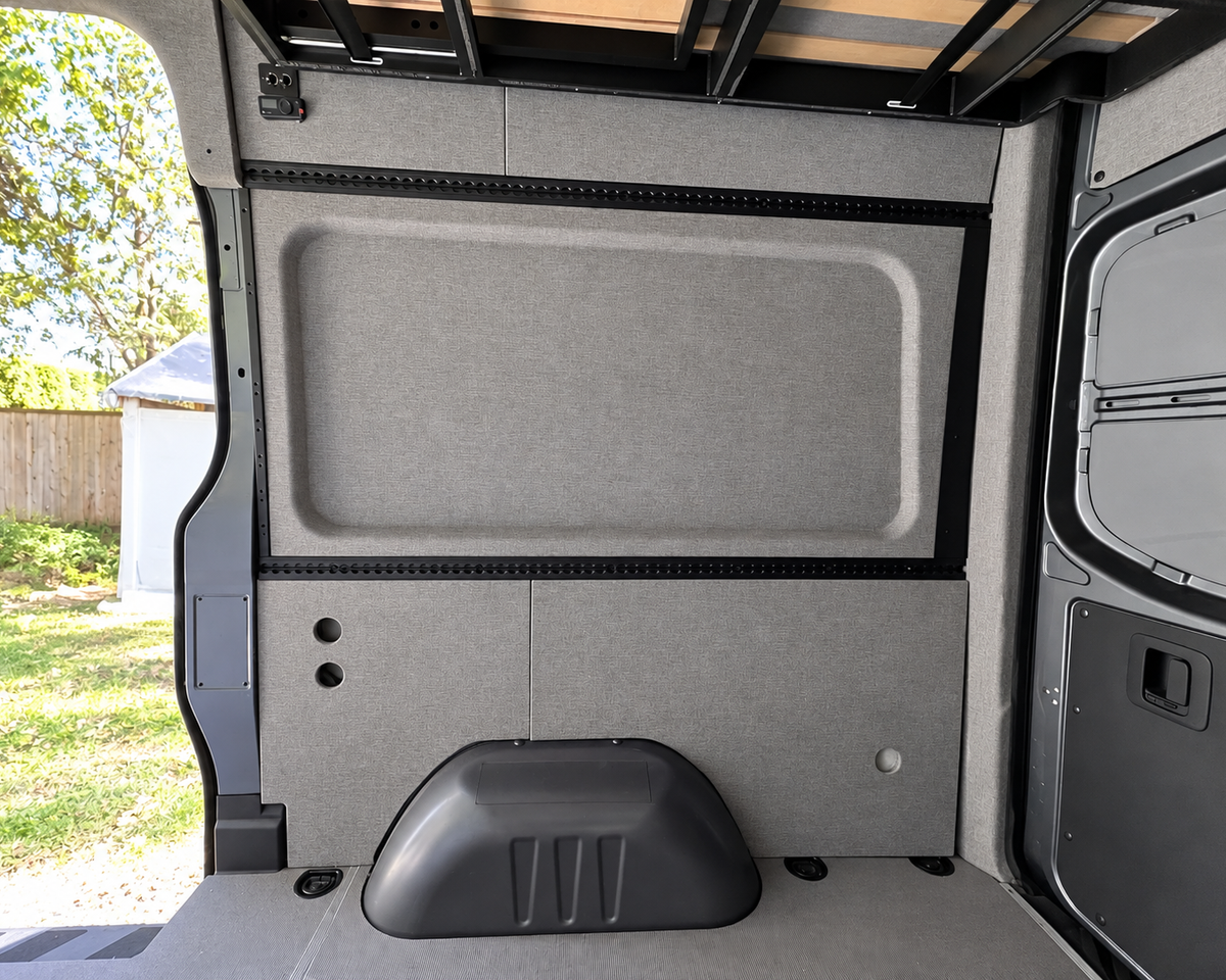 Pre-wrapped Sprinter wall panel and L-Track next to the sliding door
