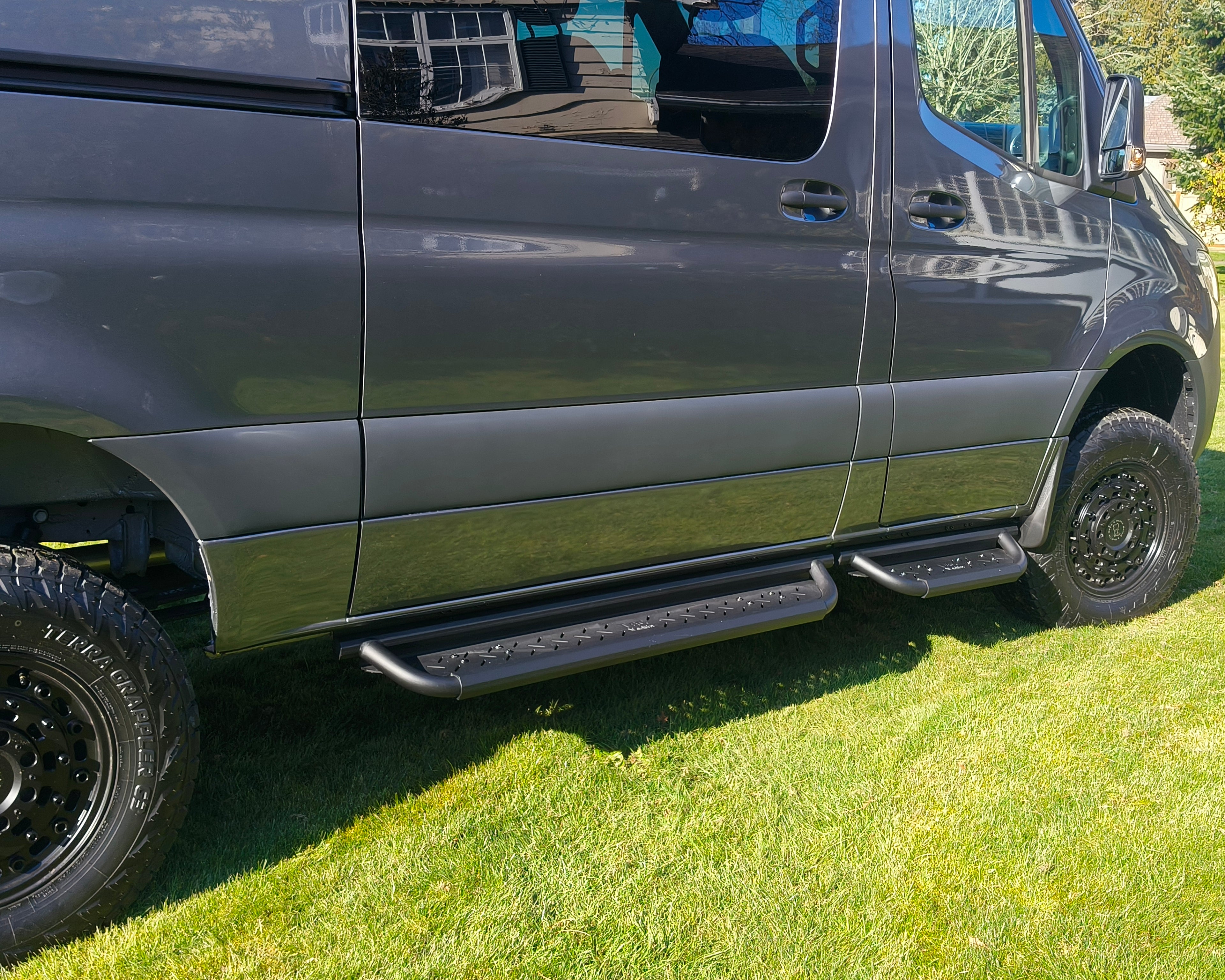 Modular coated aluminum drop down running boards for Sprinter vans.