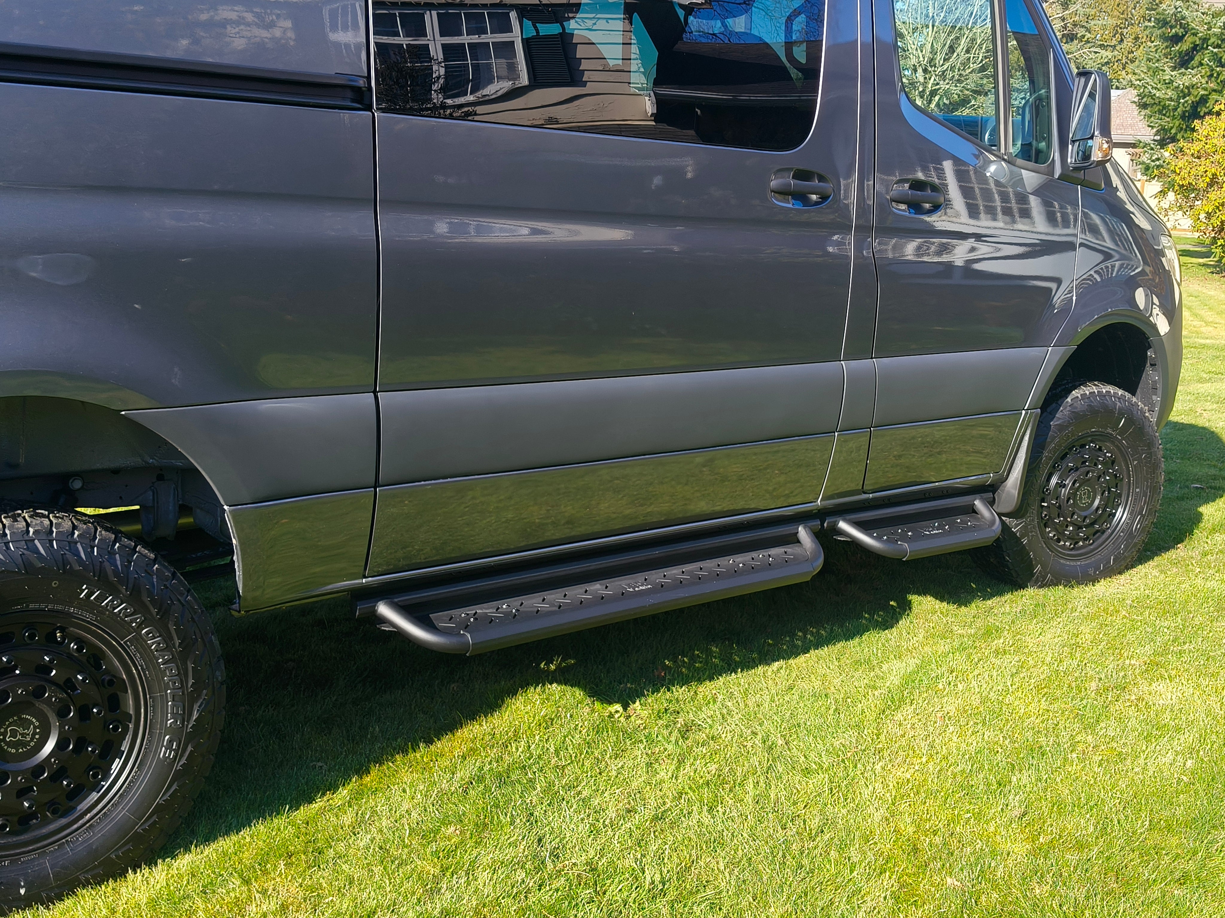 Modular coated aluminum drop down running boards for Sprinter vans.