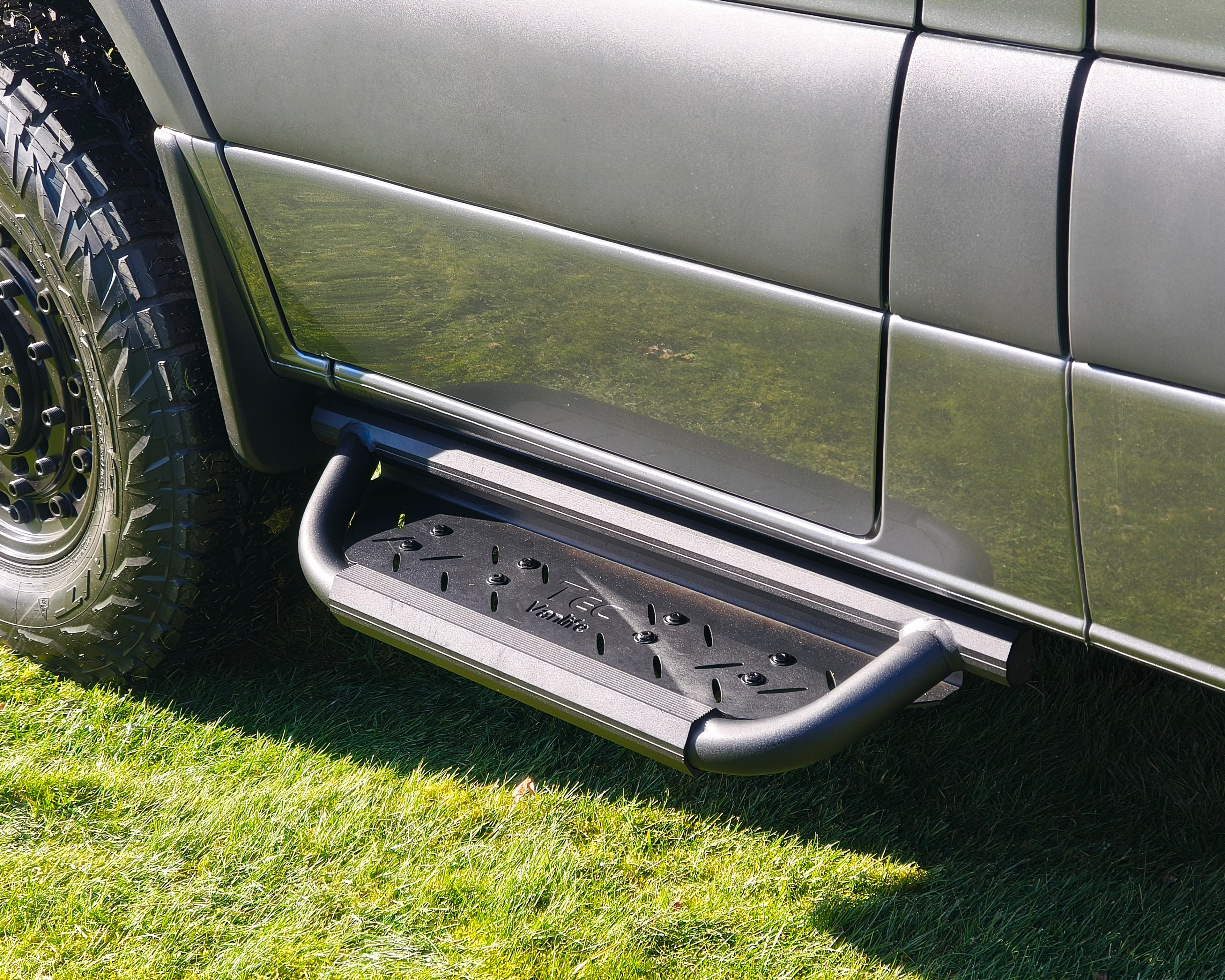 Modular drop down running boards for Sprinter vans with ribbed anti-slip footbed.