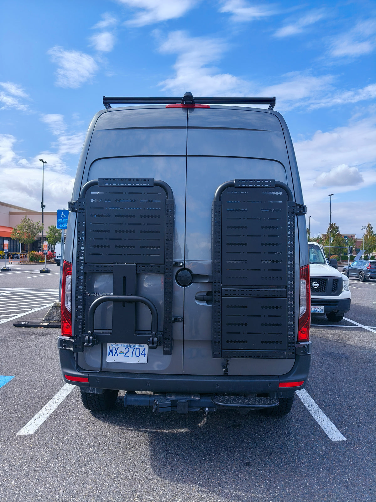 Driver side gear rack with top panel and tire carrier, paired with passenger side gear rack