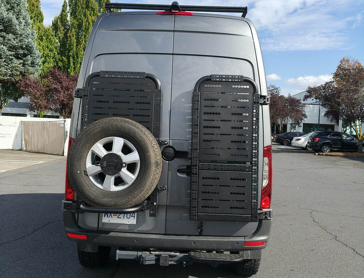 Driver side gear rack carrying a spare tire, paired with passenger side gear rack