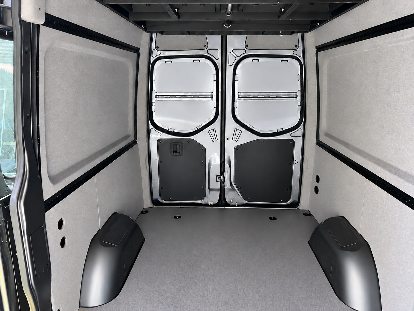 Finished Sprinter walls and wheel well area, view toward the rear doors