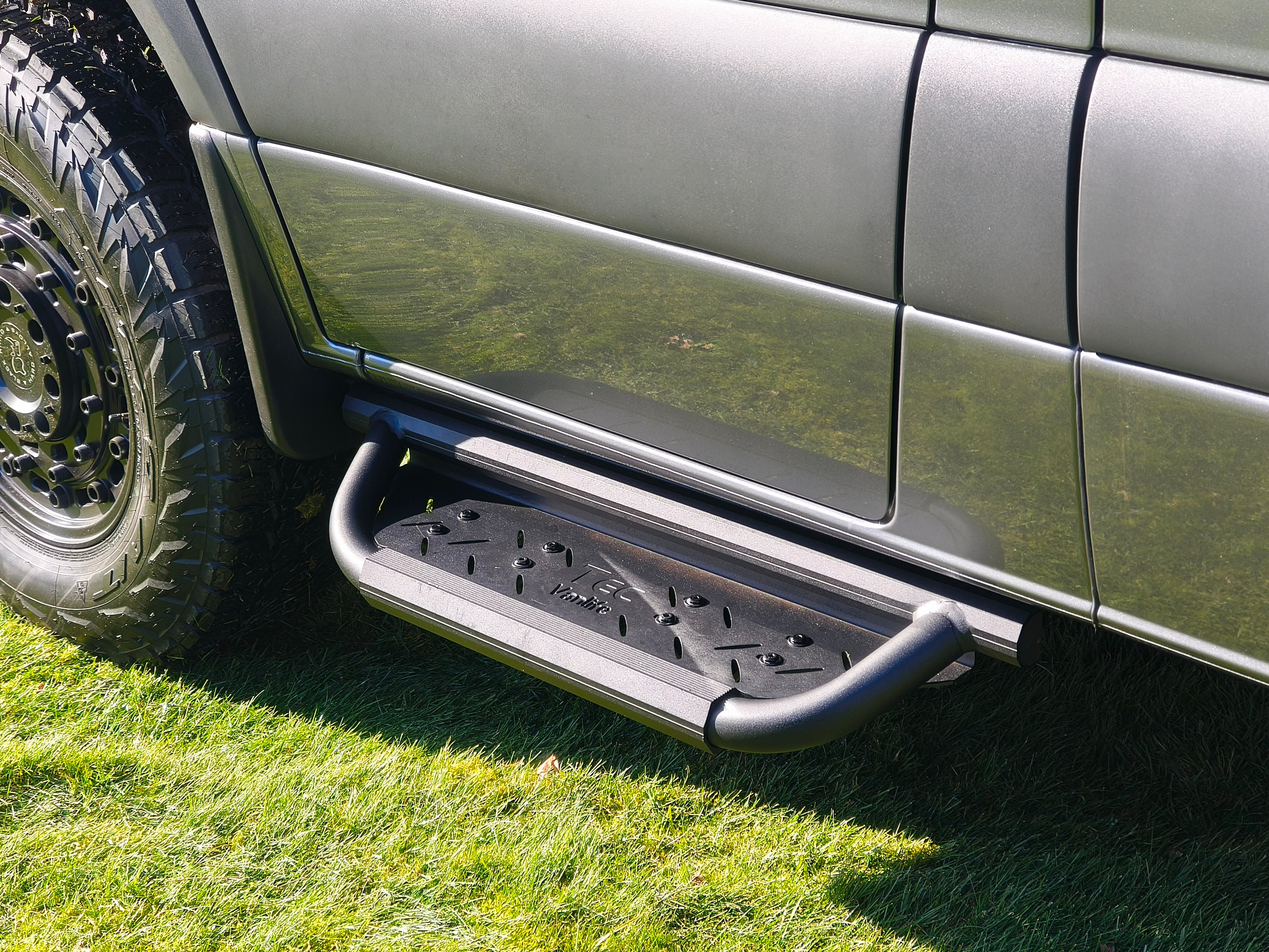 Modular drop down running boards for Sprinter vans with ribbed anti-slip footbed.