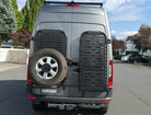 Driver side gear rack carrying a spare tire, paired with passenger side gear rack